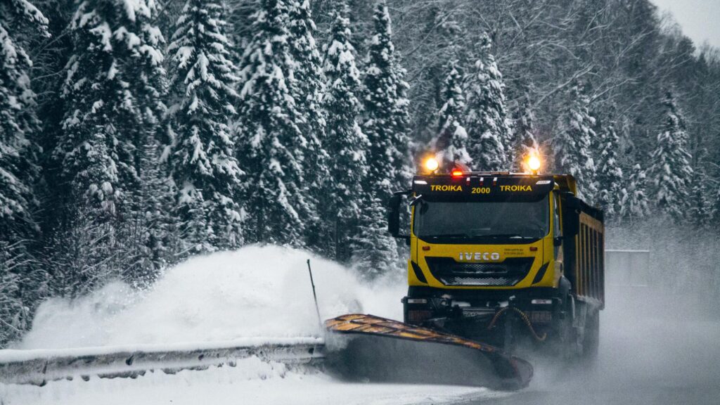 truck clearing snow in storm